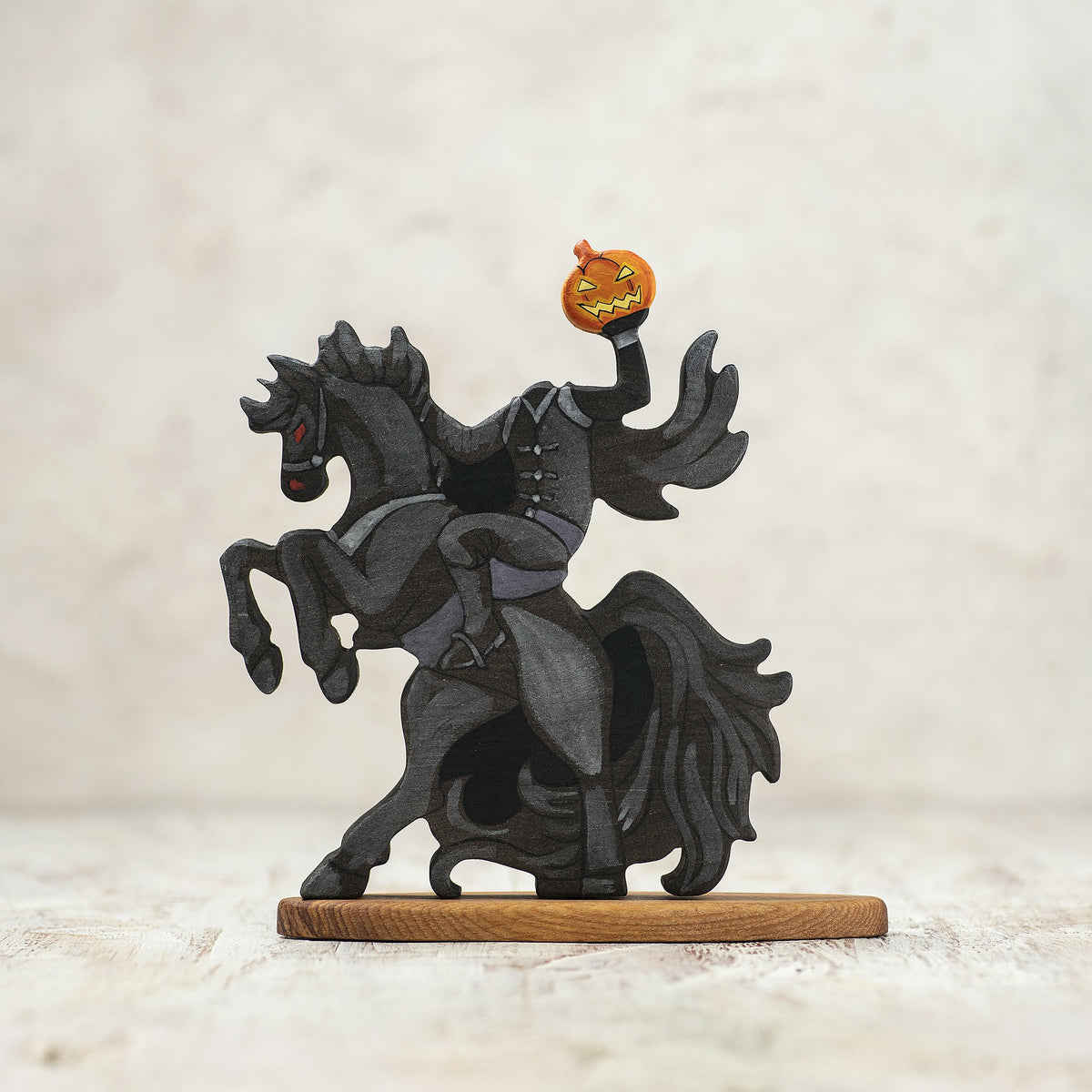 Wooden Headless Horseman riding a black horse